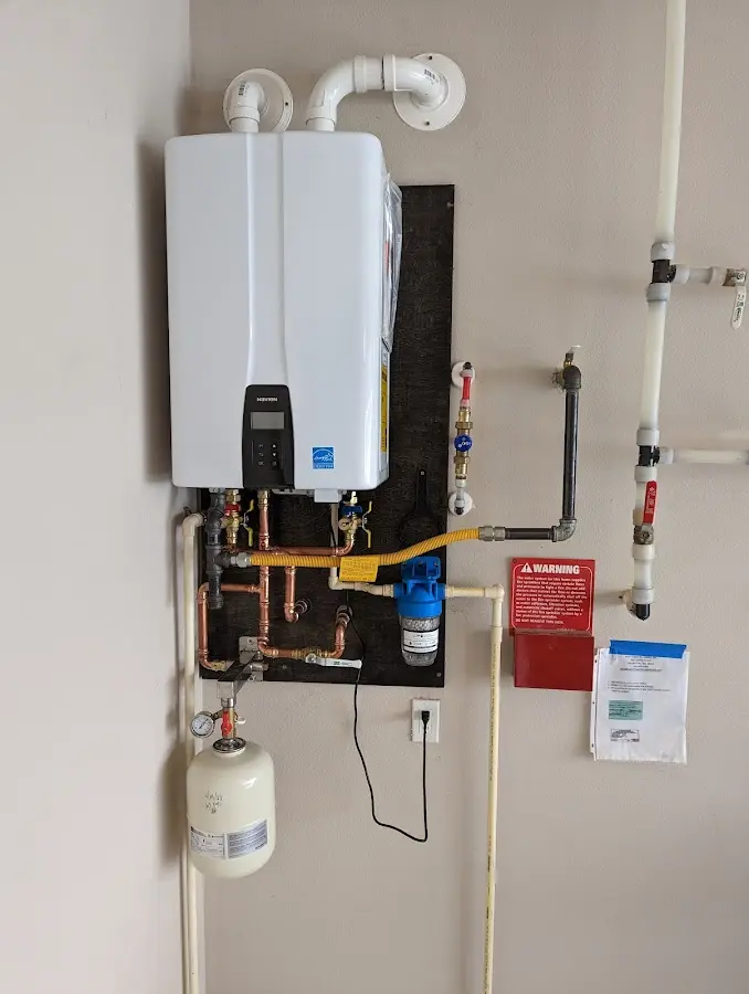 Professional plumber installing copper piping in a Suitland home